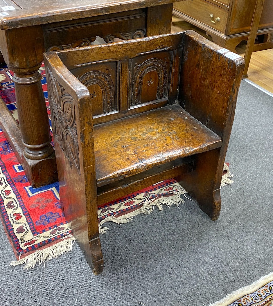 A small 17th century style oak hall seat, width 53cm, depth 29cm, height 66cm